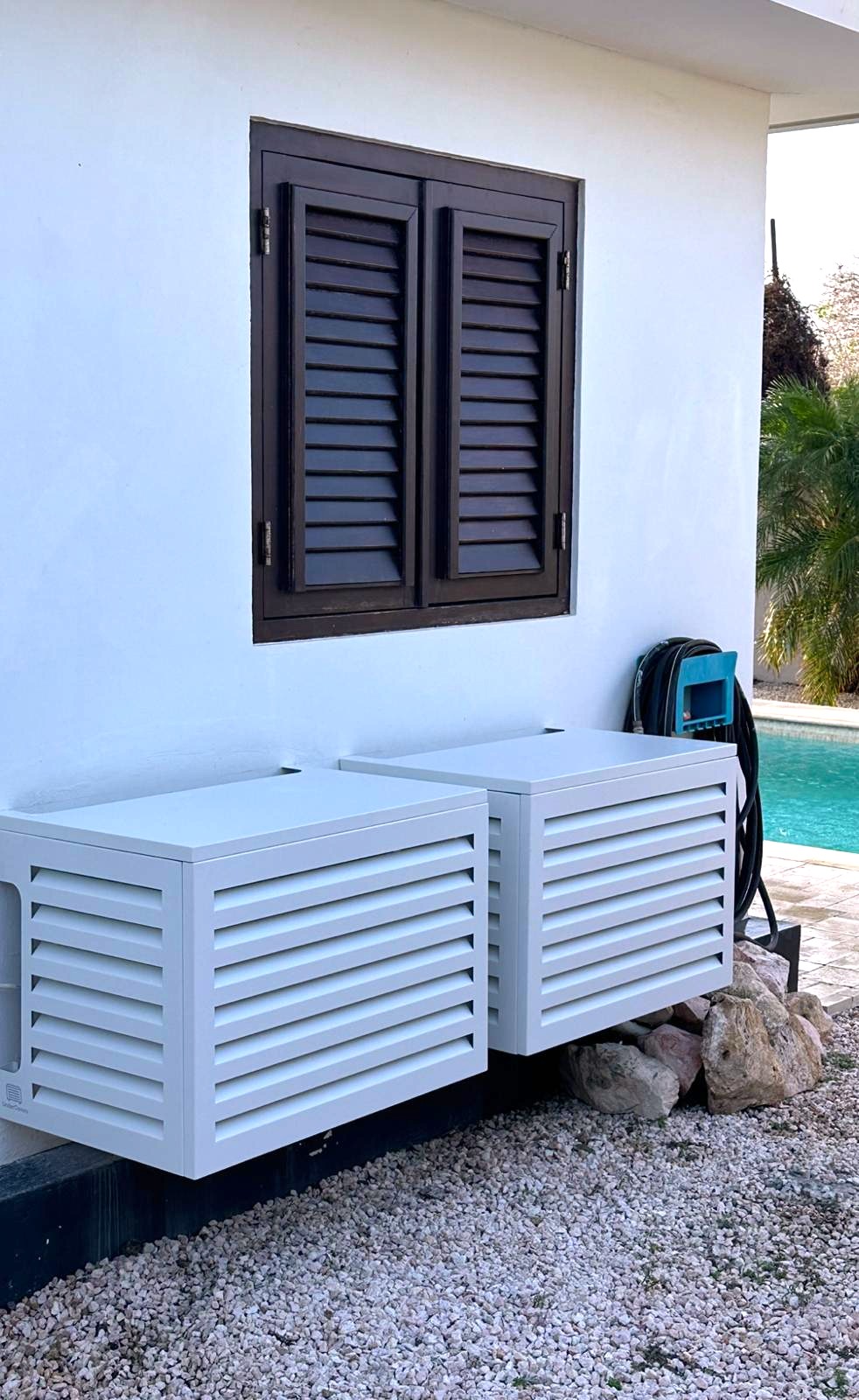 UnderCovers aluminum AC covers installed at a Curacao pool terrace